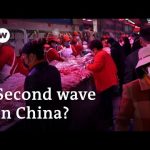 Dozens of new coronavirus cases tracked to Beijing food market | DW News